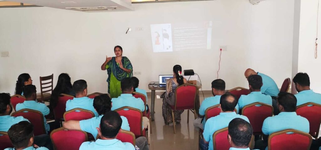 Professional trainer delivering PoSH workshop on sexual harassment prevention at workplace.